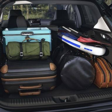 2027 Honda HR-V EX-L cargo area packed with luggage, a cooler, and a paddleboard (Subcompact Crossover SUV).