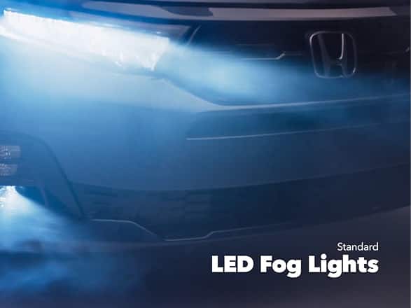 2027 Honda Odyssey Elite in Smoke Blue Pearl front studio showing standard LED fog lights and headlights (Minivan).
