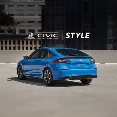2027 Honda Civic Hatchback Sport Touring Hybrid in Boost Blue Pearl back parked on a rooftop parking lot in the city (Compact Hatchback).